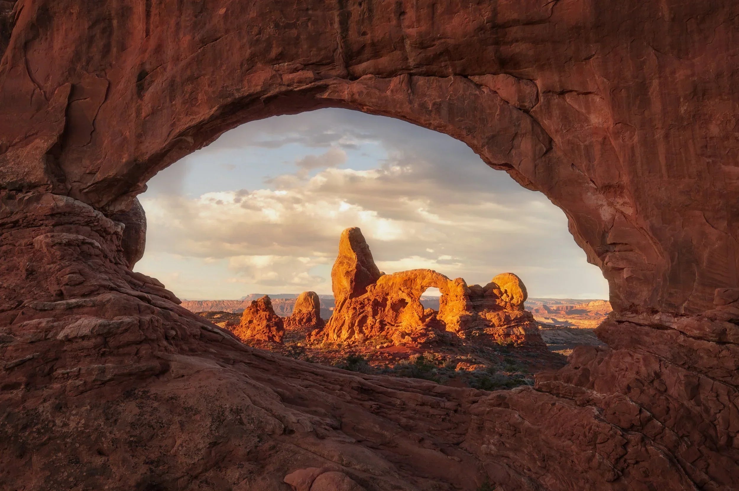North Window framing Turret Arch at sunset in Arches National Park, Utah with glowing red rock formations