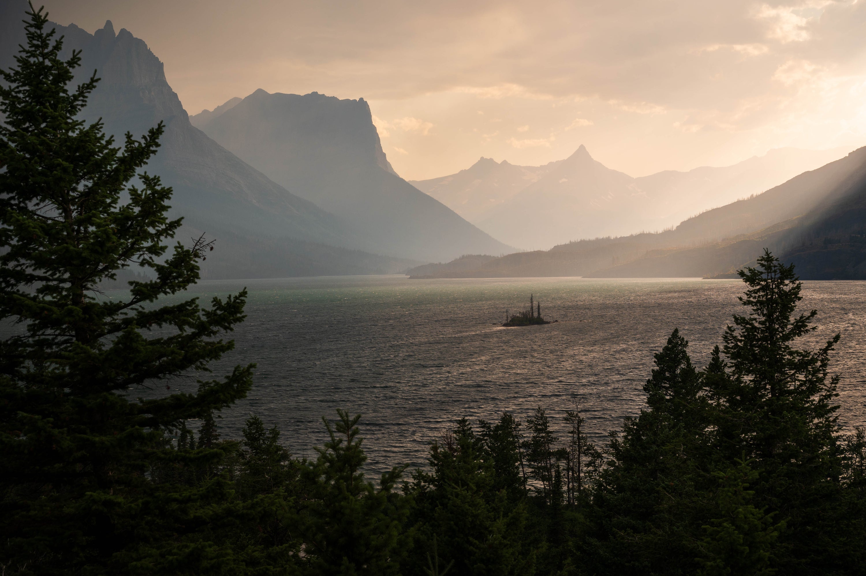 St. Mary Lake at sunset with layered mountain peaks in Glacier National Park, Montana