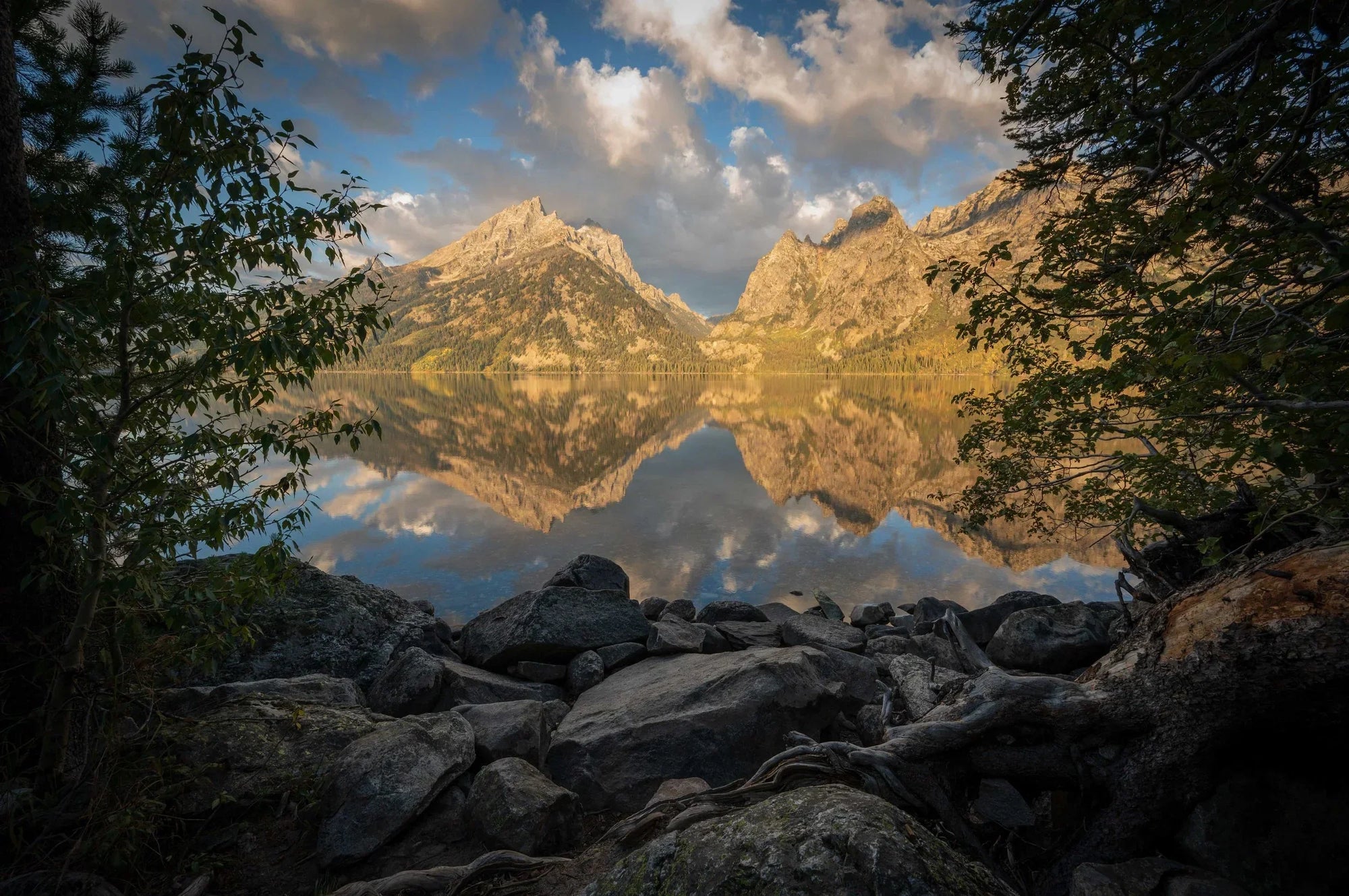 Mount Moran and the Teton Range reflected in calm water at sunrise in Grand Teton National Park, Wyoming